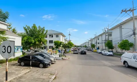 Eua Arthorn Naklua internal roadway lined with condo buildings and resident parking