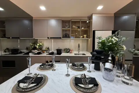 2 Bedroom Condo for Sale at Aquarous Jomtien Pattaya modern kitchen with marble countertop, induction hob and glass-front cabinets