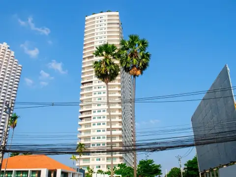 View Talay 8 high-rise condo tower exterior with balconies framed by tall palm trees