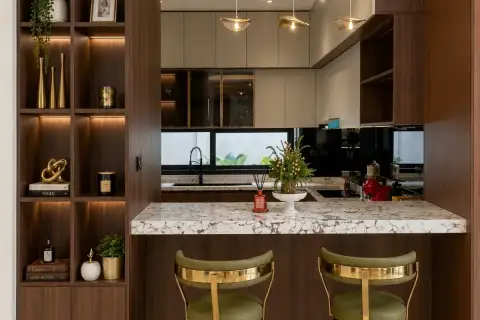 5 Bedroom House for Sale at Horizon By Patta kitchen island with marble countertop, gold bar stools and walnut shelving