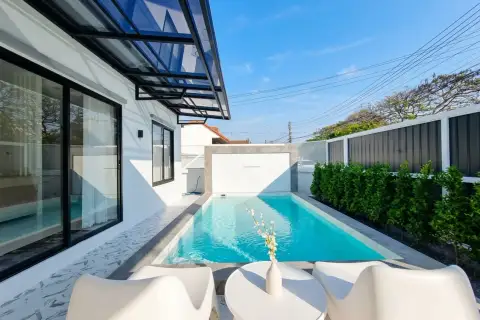 3 Bedroom House for Rent at Pattaya Green Ville poolside seating area with lap pool and garden fence