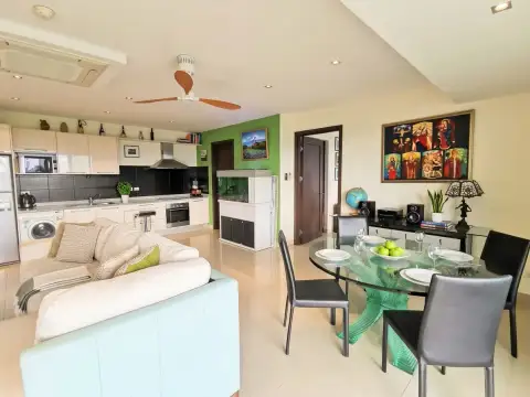 1 Bedroom Condo for Sale at The Park Jomtien open-plan living and dining area with kitchen and aquarium