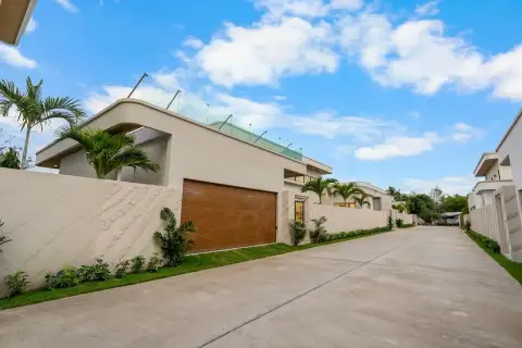 3 Bedroom House for Sale at Perla Villa, private outdoor swimming pool with lounge chairs and house exterior.