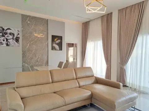 4 Bedroom House for Sale in Huai Yai living room with beige leather sofa and marble accent wall