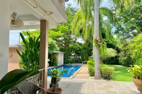 4 Bedroom House for Sale at Mountain Village 1 covered patio overlooking swimming pool and manicured garden lawn