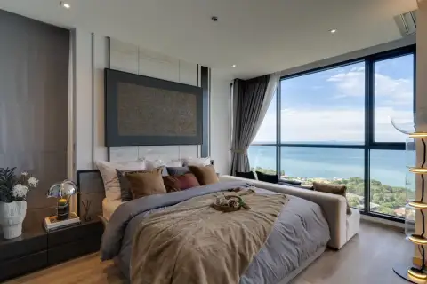 1 Bedroom Condo for Sale at Andromeda Condominium luxury bedroom with upholstered headboard, bedside lamps, and floor-to-ceiling sea view