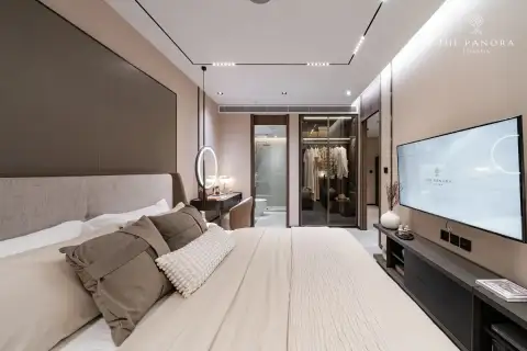 2 Bedroom Condo for Sale at Panora Estuaria bedroom with TV console and sheer curtains overlooking study nook