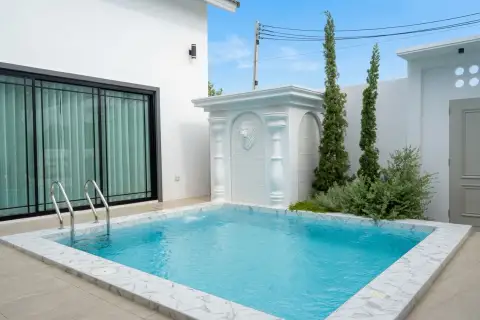 3 Bedroom House for Sale in Chak Nok poolside patio with fountain feature and sliding glass doors
