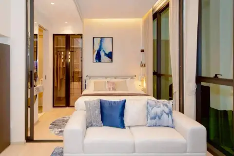 1 Bedroom Condo for Sale at Once Wong Amat bedroom with double bed, walk-in wardrobe, sofa, and floor-to-ceiling windows
