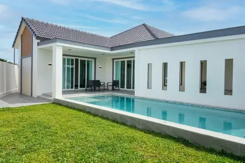 3 Bedroom House for Sale at Boonraksa​ Haven​ backyard with private swimming pool, covered patio, and lush green lawn