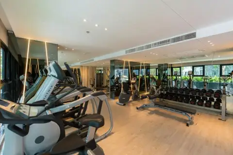 Nirvana Place fitness center with treadmills, cardio machines, and dumbbell rack