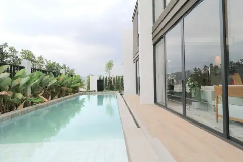 Highbury Hill Pool Villas Pattaya private lap pool with timber deck and large sliding glass doors