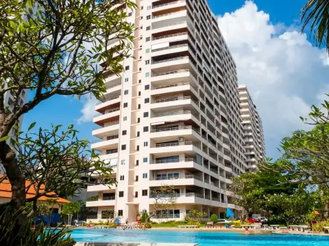 View Talay 3A condo building exterior with tiered balconies and landscaped pool garden