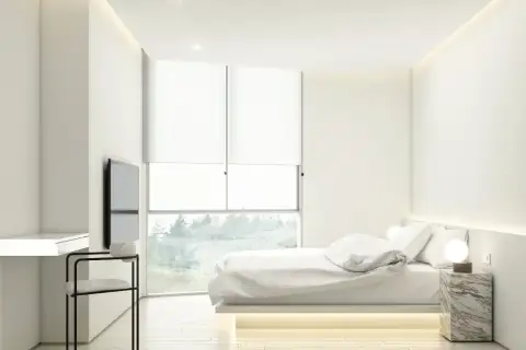2 Bedroom Condo for Sale at Secret Garden Condominium, bedroom with large window, bed, and desk area.