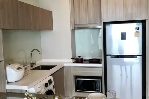 1 Bedroom Condo for Sale at Cetus Beachfront fully equipped kitchen with wood cabinets, stainless fridge and washing machine