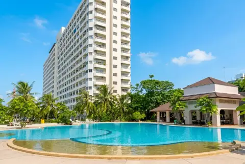 View Talay 1 tower exterior overlooking lagoon-style pool and clubhouse amenities