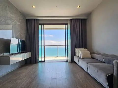 2 Bedroom Condo for Sale at Aeras living room with gray sofa, TV, and balcony sea view
