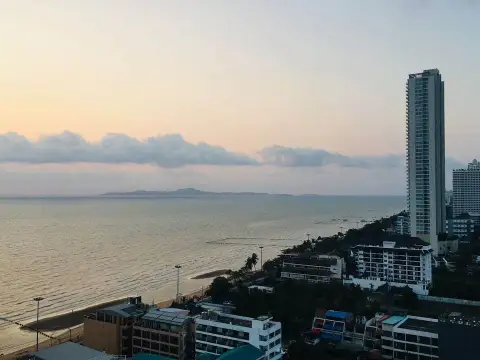 2 Bedroom Condo for Sale at Aeras sunset view of Pattaya coastline and high-rise skyline from balcony