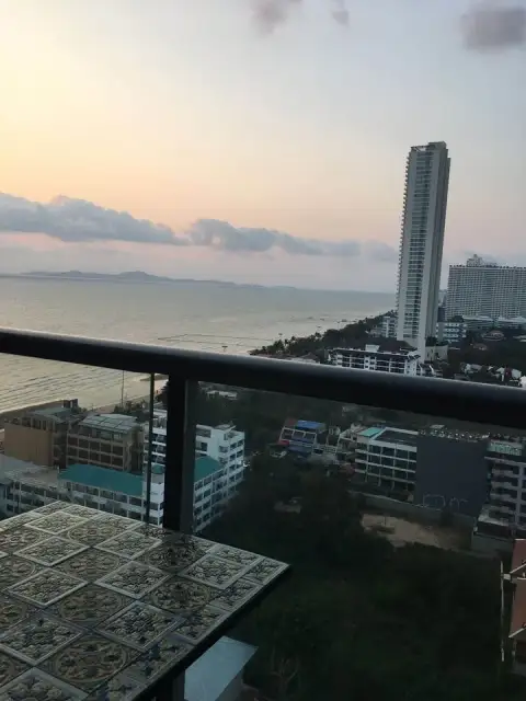 2 Bedroom Condo for Sale at Aeras balcony view of sea, beach and city skyline at dusk