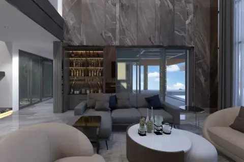 Alicera Ville elegant living area with a grey sectional sofa, built-in bar, and view of an outdoor pool.