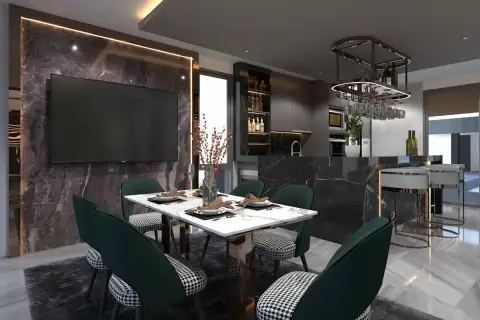 Alicera Ville dining area with a white marble table, green chairs, and a large wall-mounted TV.