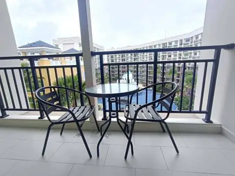 2 Bedroom Condo for Rent at Arcadia Beach Continental private balcony with table, chairs and pool view