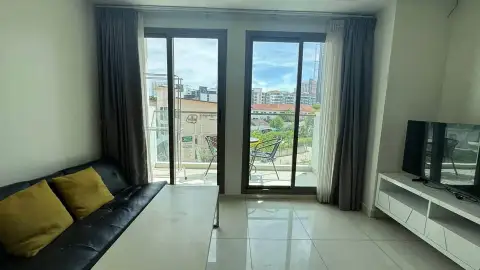 2 Bedroom Condo for Sale at Arcadia Beach Resort balcony view with sliding glass doors and city skyline