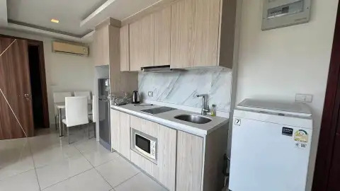 2 Bedroom Condo for Sale at Arcadia Beach Resort kitchenette with marble backsplash and sink area