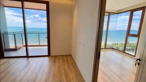 2 Bedroom Condo for Sale at Arom Jomtien hallway connecting balcony and bedroom with panoramic ocean views