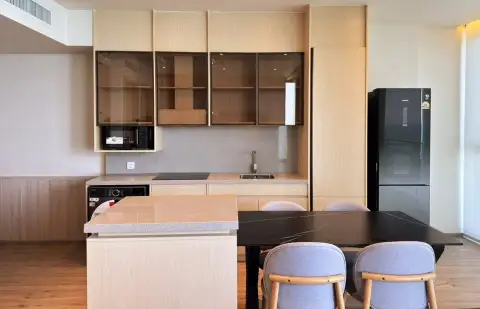 2 Bedroom Condo for Sale at Arom Wongamat kitchen with wood cabinetry, dining table and black refrigerator