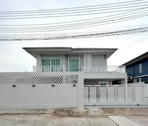4 Bedroom House for Sale at Baan Pruksa Nara Chaiyapruek two-story exterior facade with white gate and perimeter wall