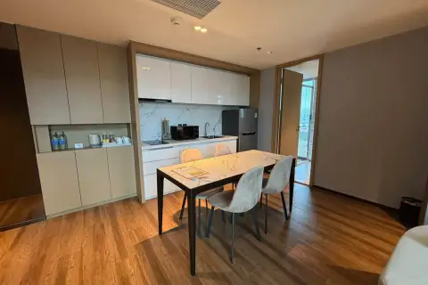 2 Bedroom Condo for Rent at Beverly Mountain Bay Pattaya modern kitchenette with marble backsplash, dining table and balcony access