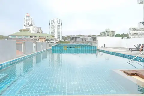 C View Residence 2 rooftop view of Pattaya cityscape with red-roofed buildings and high-rise condos under blue sky