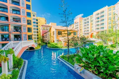 Venetian Signature Condo Resort canal-style pool with bridge winding through colorful low-rise buildings