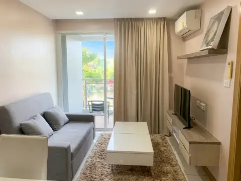 1 Bedroom Condo for Sale at Whale Marina living room with gray sofa, TV unit and balcony access