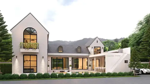 Castle Hill modern house with black and orange accents, lush trees, and blue sky.