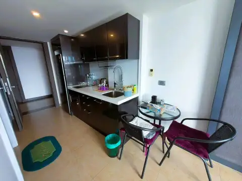 Studio Condo for Sale at Centara Avenue Residence and Suites compact kitchenette with dining table and chairs