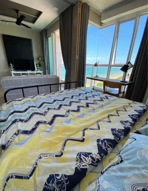 1 Bedroom Condo for Sale at Cetus Beachfront bed with ocean view through floor-to-ceiling windows