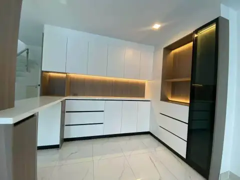 5 Bedroom House for Rent at Chokchai 9 modern kitchen with white cabinetry and wood accent shelving