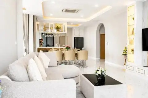 4 Bedroom House for Sale at Chokchai Garden Home 2, dining area with a white marble table, six chairs, and large windows.