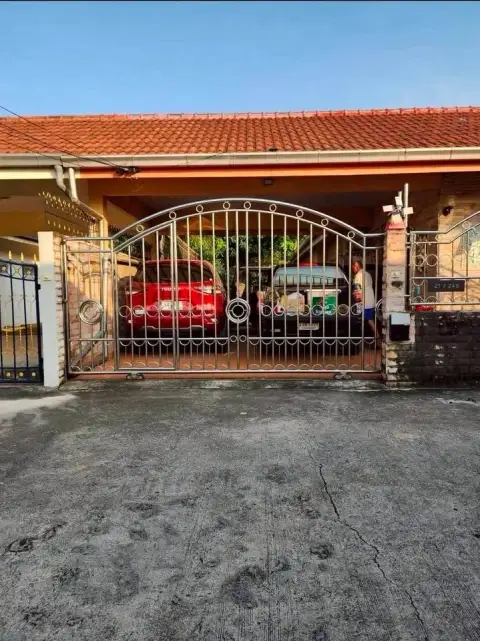 4 Bedroom House for Sale at Chokchai Garden Home 2 steel gate entrance with carport and parked cars