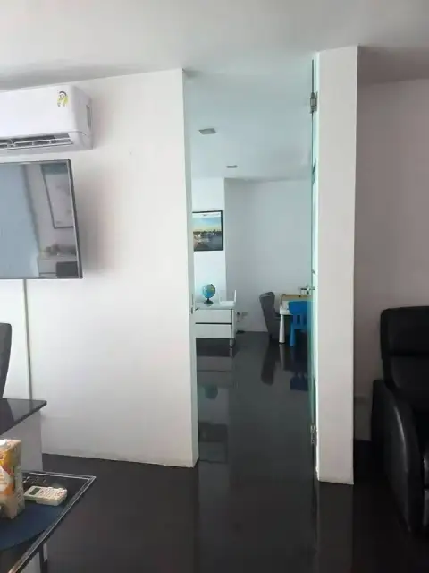 1 Bedroom Condo for Sale at Club Royal hallway view leading to secondary room with globe decor