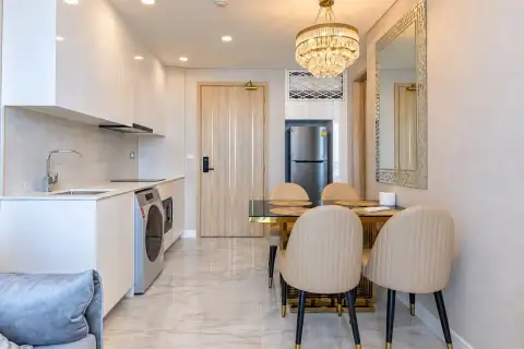 1 Bedroom Condo for Sale at Copacabana Beach Jomtien hallway with dining area, kitchenette and wood entrance door