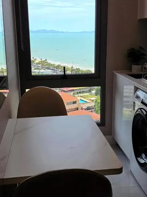 1 Bedroom Condo for Rent at Copacabana Beach Jomtien dining table with ocean view through window