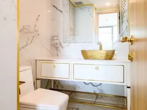 2 Bedroom Condo for Rent at Copacabana Beach Jomtien marble bathroom with gold vessel sink and toilet