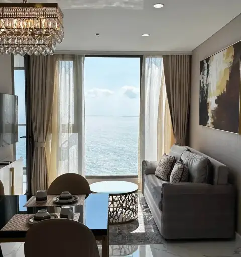 2 Bedroom Condo for Rent at Copacabana Beach Jomtien living room with gray sofa and panoramic ocean view window