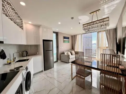 1 Bedroom Condo for Sale at Copacabana Beach Jomtien open-plan kitchen and dining area with crystal chandelier and ocean view window