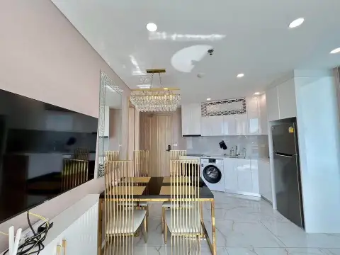 1 Bedroom Condo for Sale at Copacabana Beach Jomtien kitchen and dining area with marble flooring and mirrored wall decor