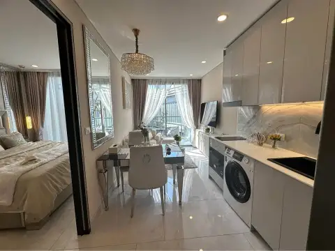 1 Bedroom Condo for Sale at Copacabana Coral Reef open-plan kitchen with dining table and bedroom view