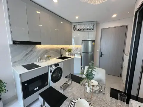 1 Bedroom Condo for Sale at Copacabana Coral Reef modern kitchen with marble backsplash and washing machine